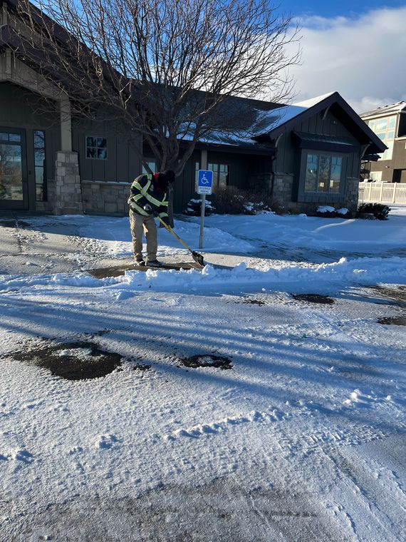 Hand-clearing an entryway after snowfall